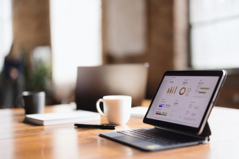 Two laptops on a desk in an office