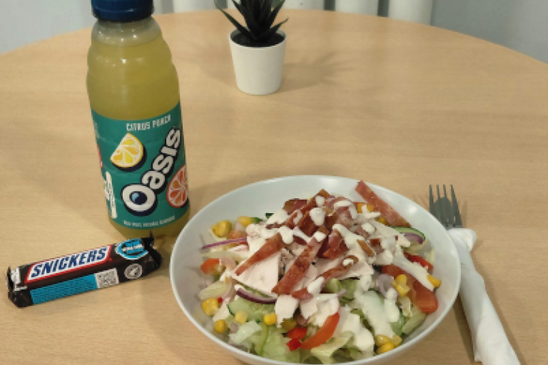 A main meal, snack and drink on a table in the cafe.