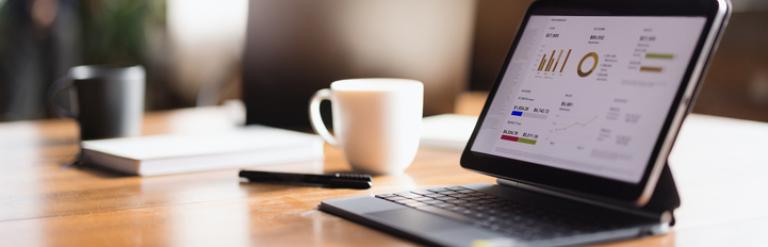 Two laptops on a desk in an office